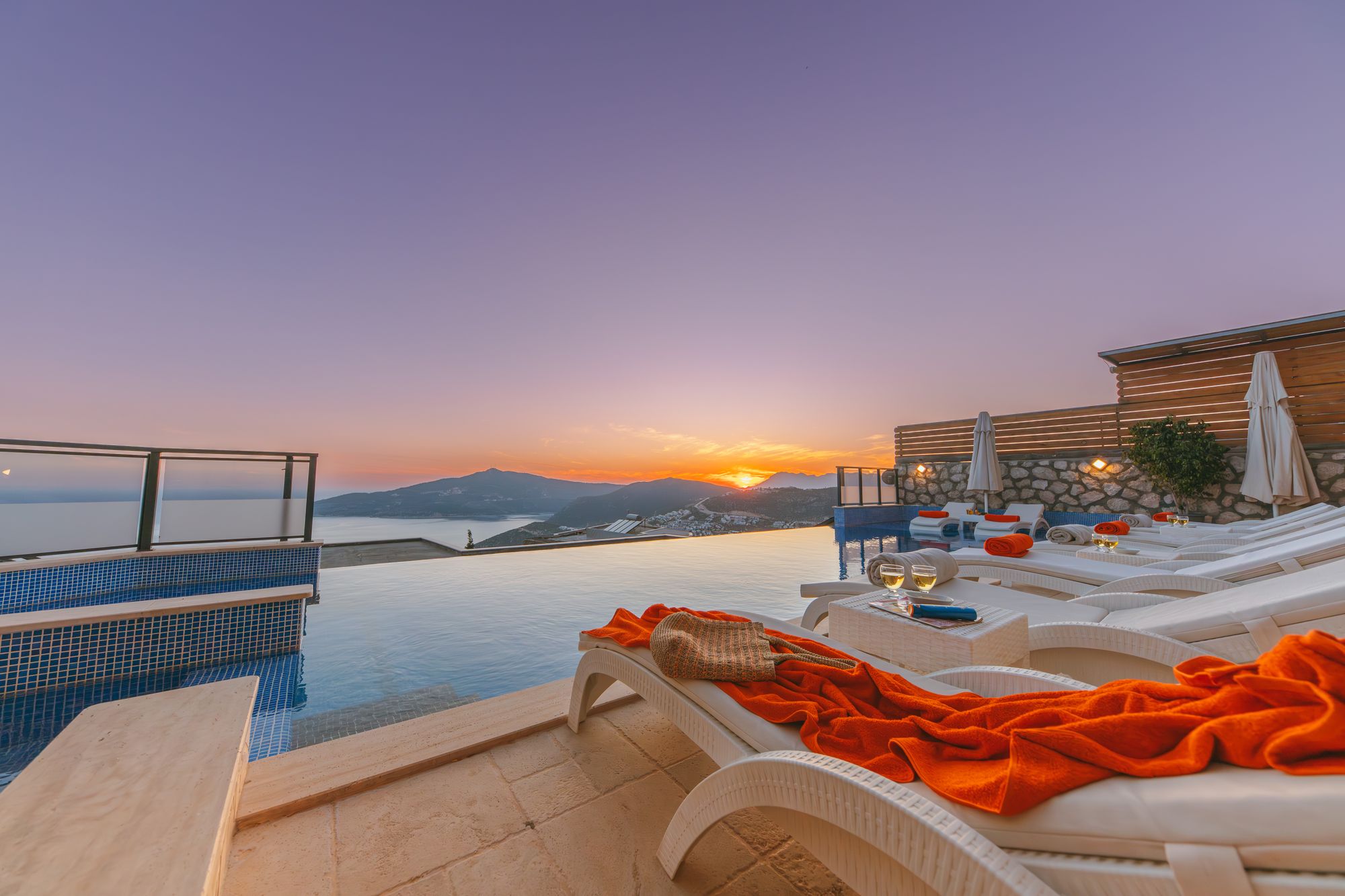 Pool loungers facing the sunset